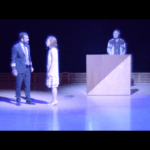 This scene of MR being given an award for her beam screen by Captain Chefone says all you need to know how things are going with the remaining folks aboard the Aniara ten years into their “mission” through deep space.